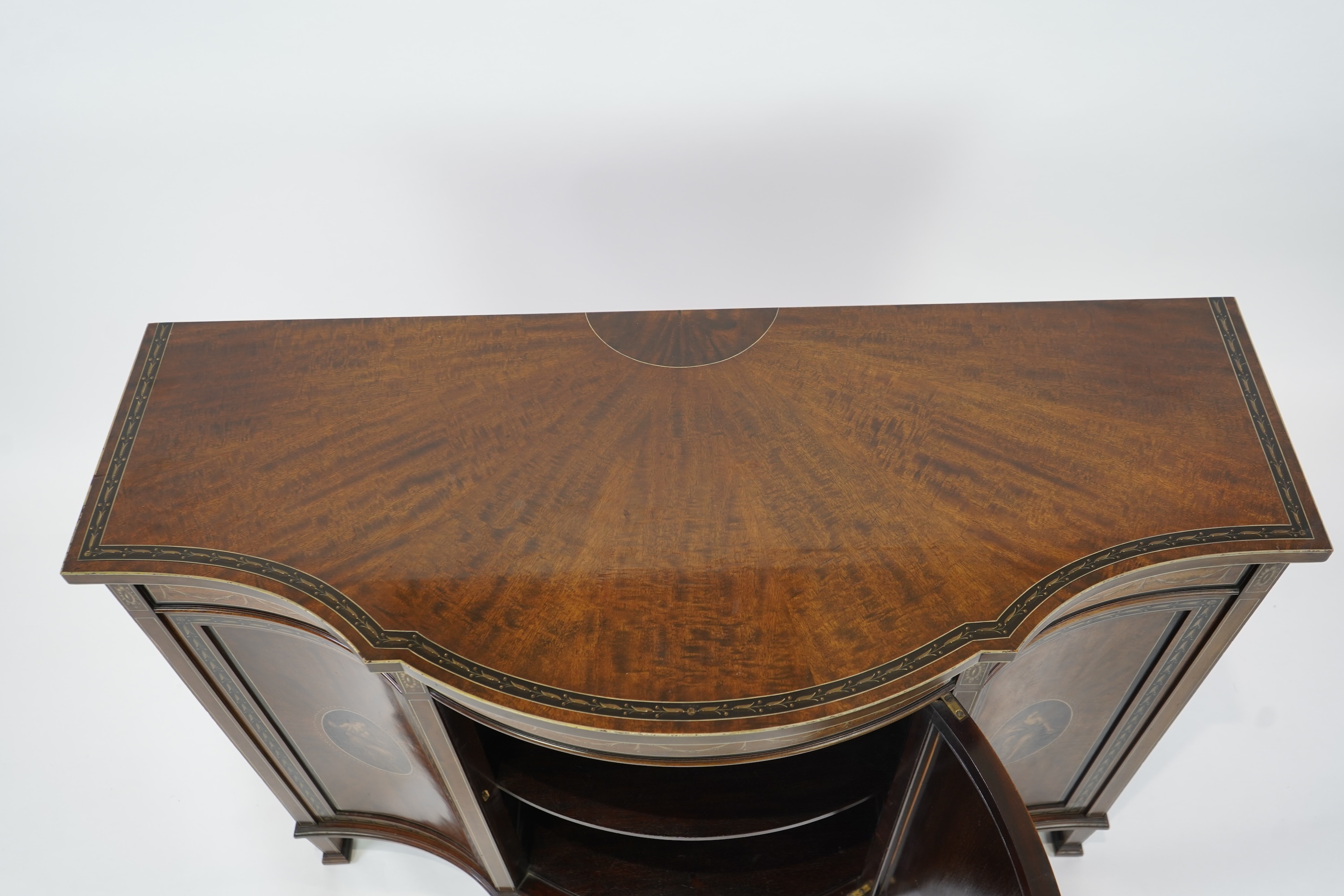 An Edwardian Sheraton Revival painted mahogany bowfront side cabinet